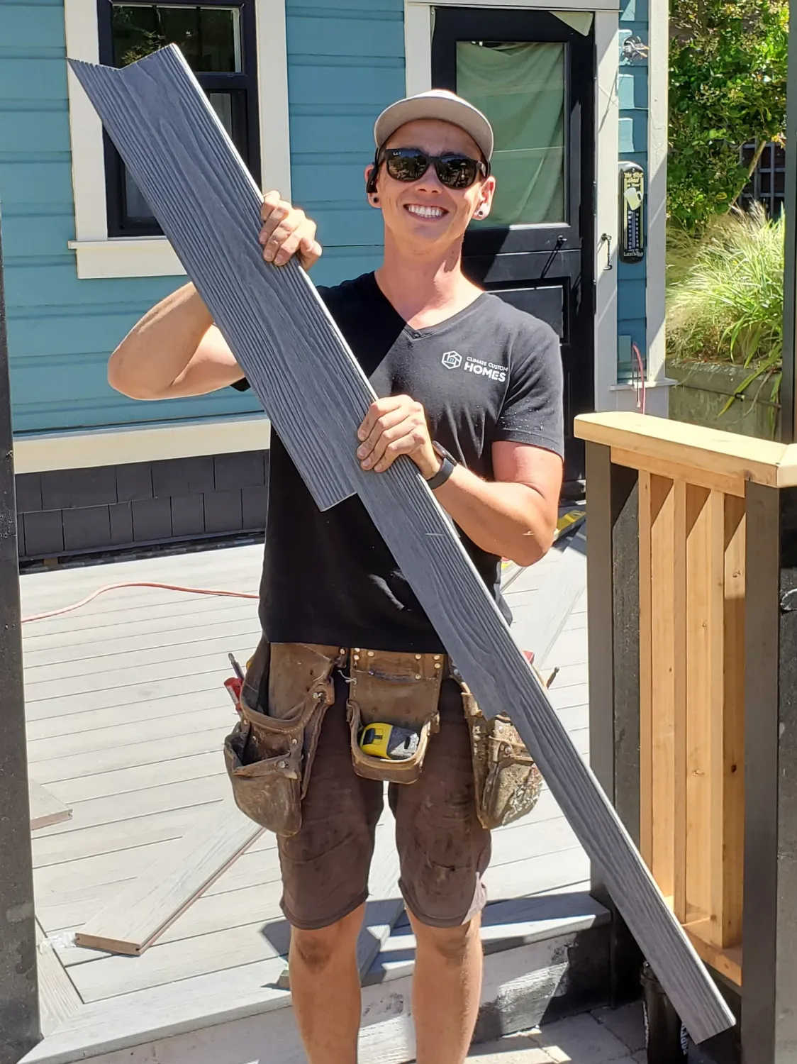 Matt Turnbull smiling and holding composite board